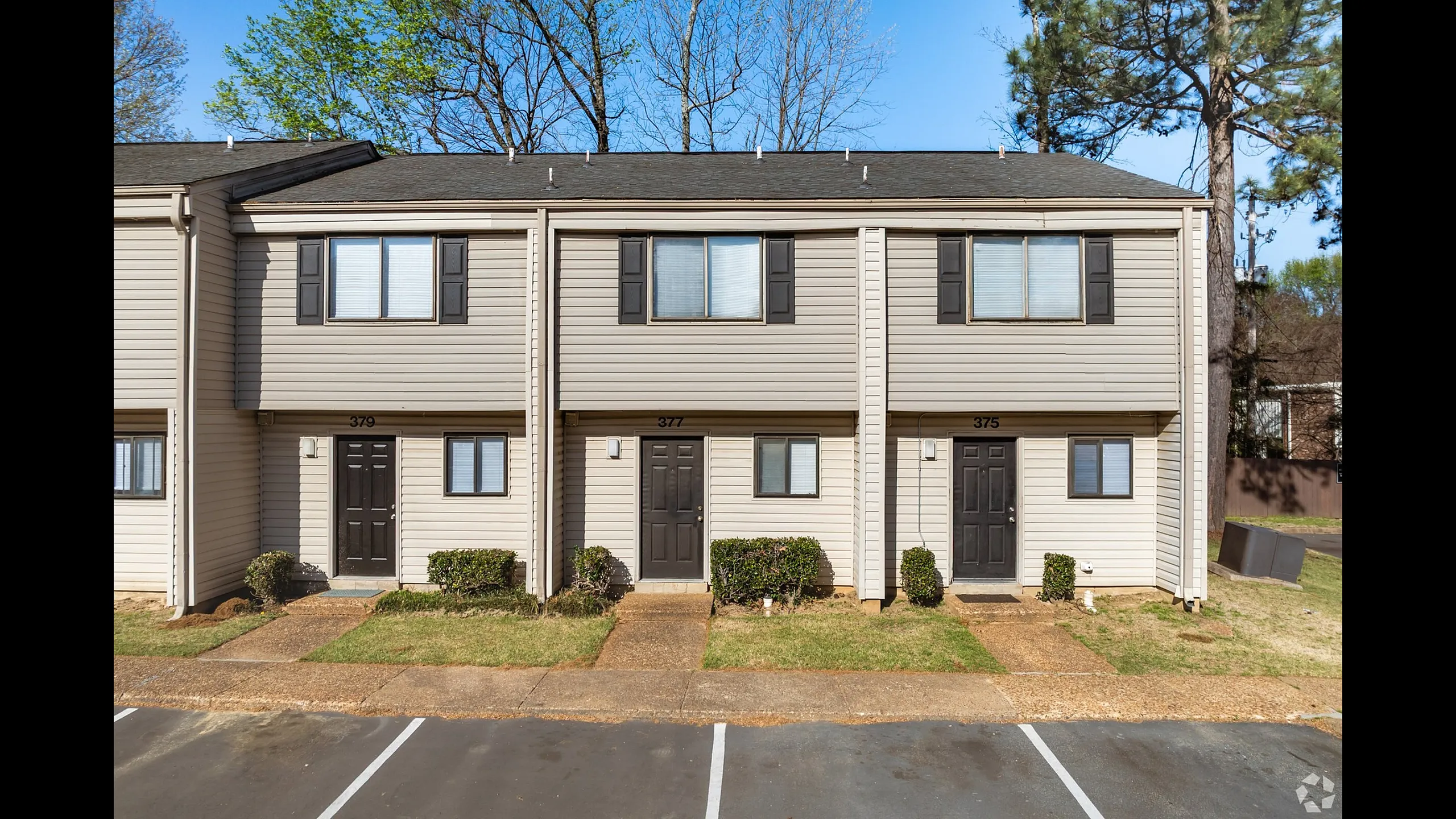 Two-story townhomes with front parking at Collier Village Apartments in Collierville, TN