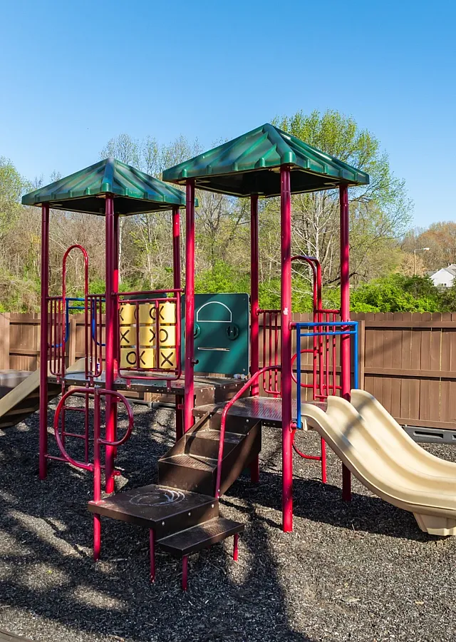 Playground with slides on mulch at Collier Village Apartments in Collierville, TN