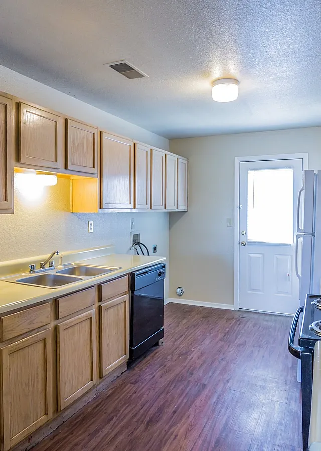 Kitchen with wood cabinets and black range at Countryside Village in Memphis, TN
