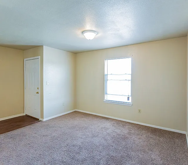 Carpeted bedroom with window at Countryside Village in Memphis, TN