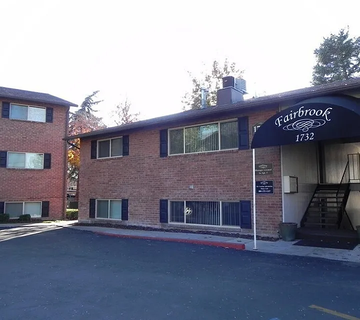 Front entry with a navy awning and community sign at Fairbrook in Salt Lake City, UT