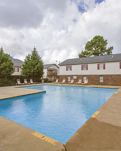 Outdoor swimming pool with sun deck at Foxhaven Apartments in Southaven, MS