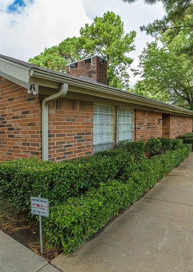 Brick leasing office with hedges at Foxhaven Apartments in Southaven, MS