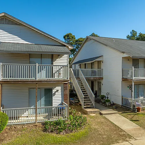 Brick and siding building with balconies at Foxhaven Apartments in Southaven, MS