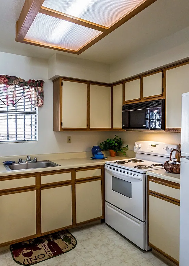 Model kitchen with white appliances at Hickory Forest in Memphis, TN