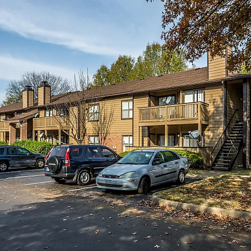 Two-story apartment buildings with resident parking at Hickory Forest in Memphis, TN