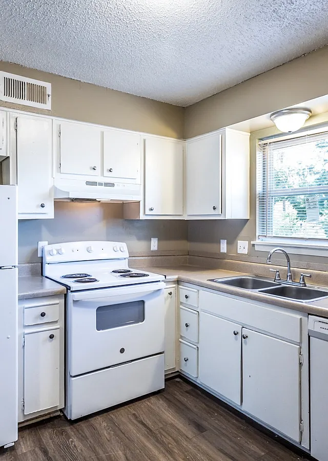 White kitchen with a window over the sink at Hunter Oaks Apartments in Memphis, TN