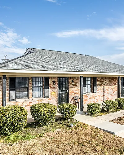 Brick ranch home with trimmed shrubs at Jackson Heights Residential in West Memphis, AR