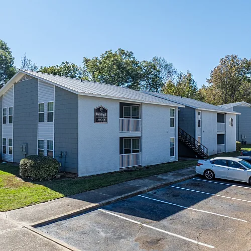 Apartment homes with green lawns at Meadow Creek Apartments in Jackson, MS