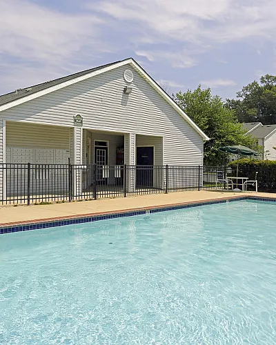 Resort-style outdoor pool with clubhouse at Meadows West Memphis Apartments in West Memphis, AR