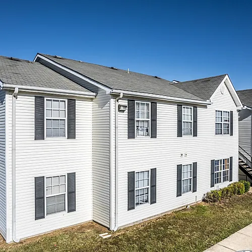 Two-story residential building with lawn at Meadows West Memphis Apartments in West Memphis, AR