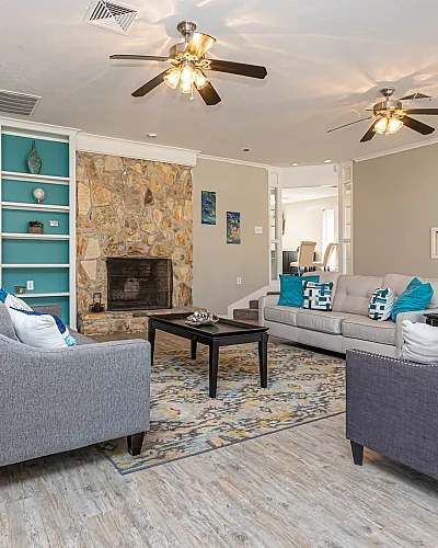 Clubhouse lounge with fireplace and comfy seating at Trails at Northpointe in Jackson, MS