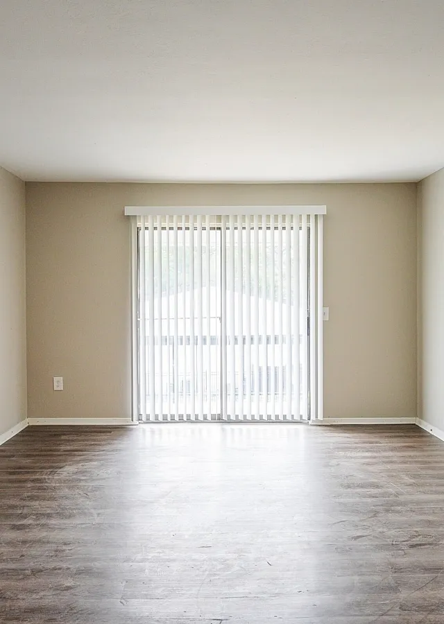 Bright living room with wood-style floors at Trails at Northpointe in Jackson, MS