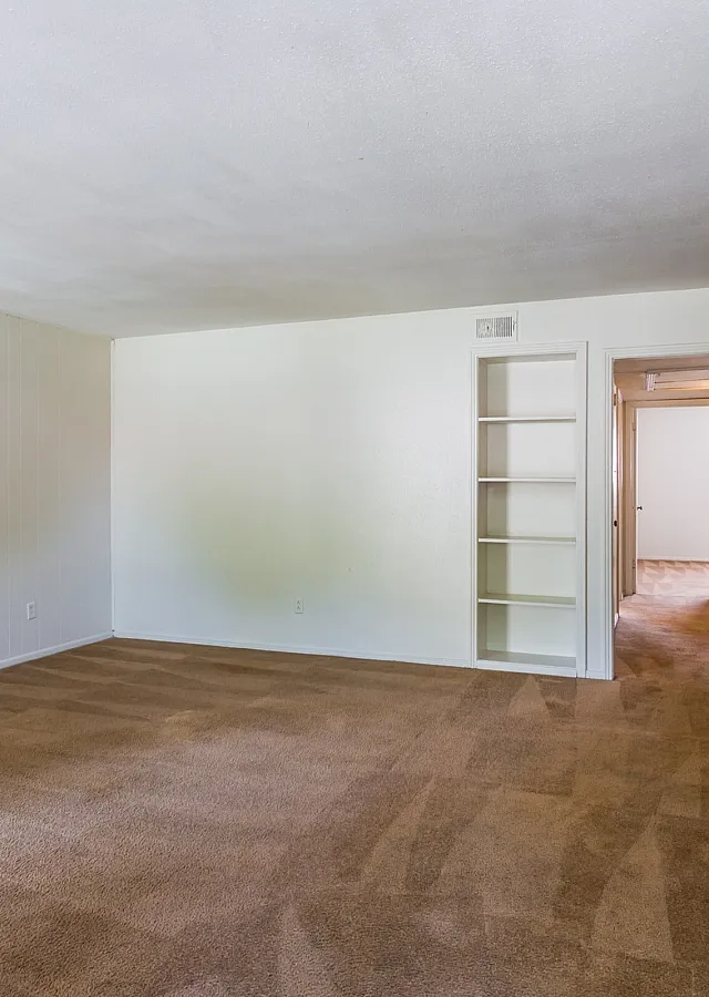 Roomy carpeted living room with open doorway at Windsor Place Apartments in Memphis, TN