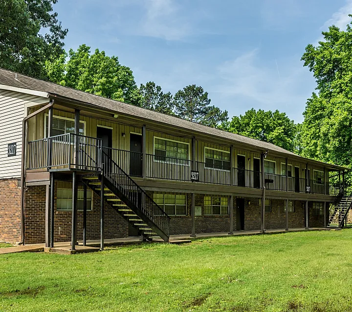 Two-story building with outdoor stairs and lawn at Windsor Place Apartments in Memphis, TN