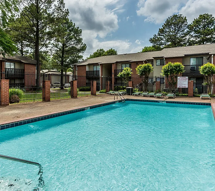 Blue outdoor pool surrounded by a brick deck at Hickory Pointe in Memphis, TN