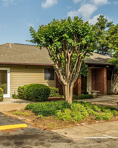 Leasing office exterior with landscaped beds at Hickory Pointe in Memphis, TN