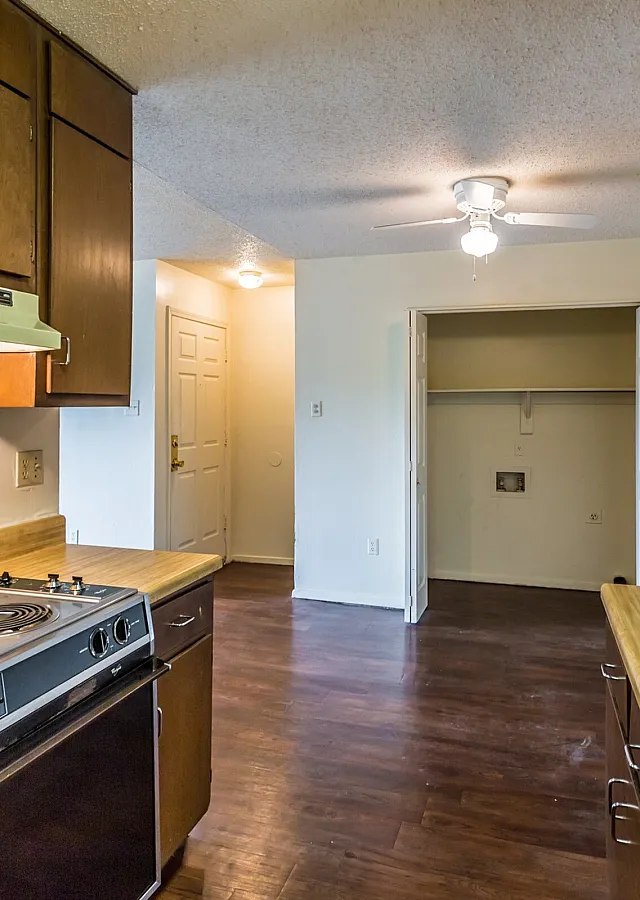 Kitchen with warm wood cabinets and a range hood at Hickory Pointe in Memphis, TN