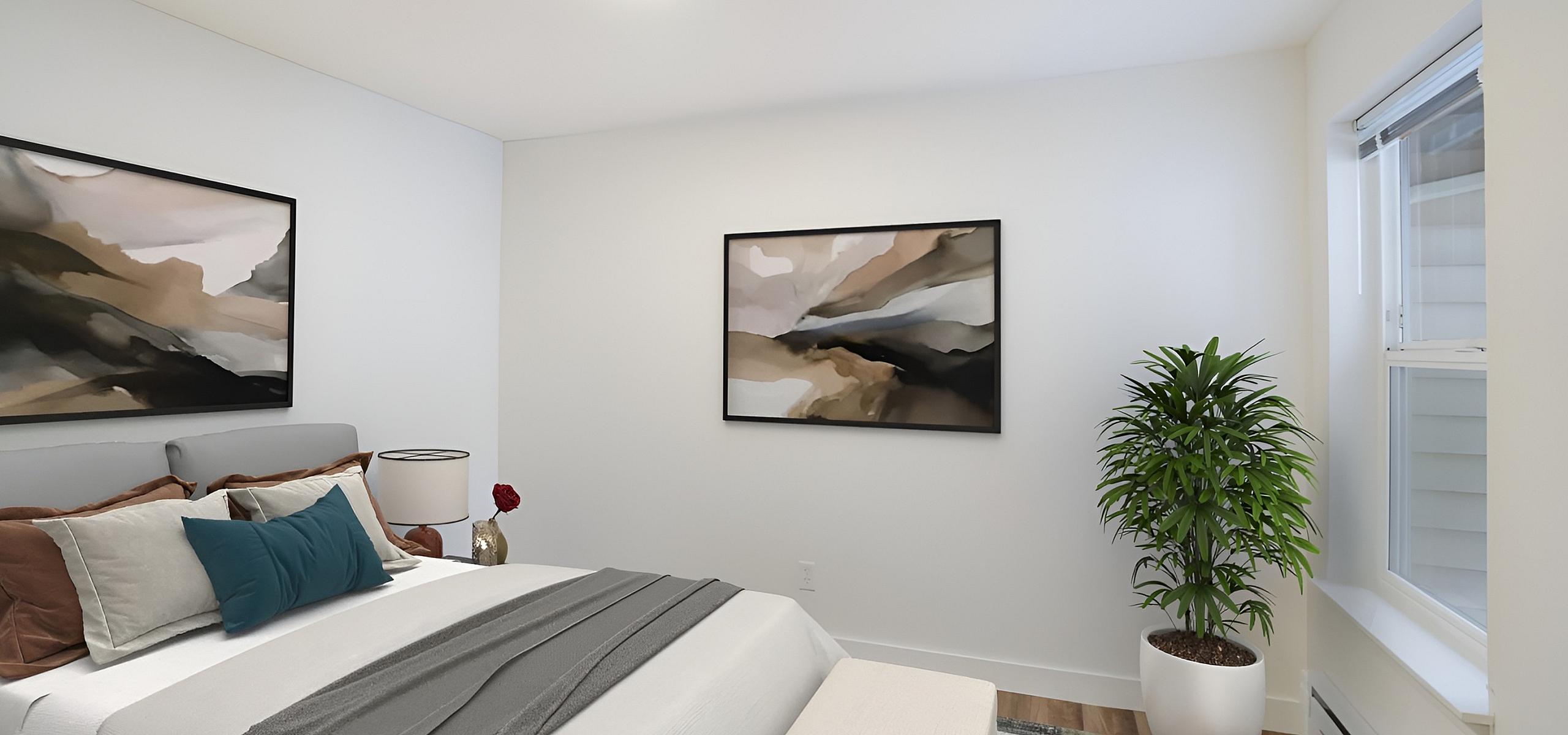 Elegant bedroom featuring modern artwork, plush bedding, and a potted plant beside a bright window.