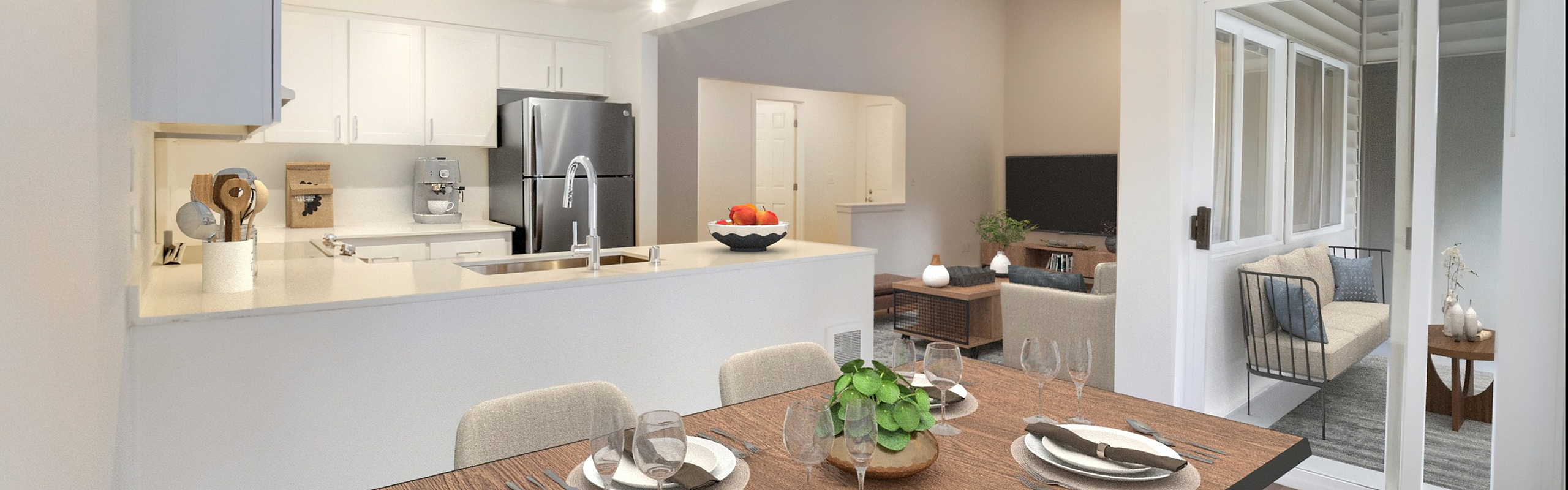 Elegant open-concept dining and kitchen area with modern appliances, adjacent cozy living room, and sunlit patio.
