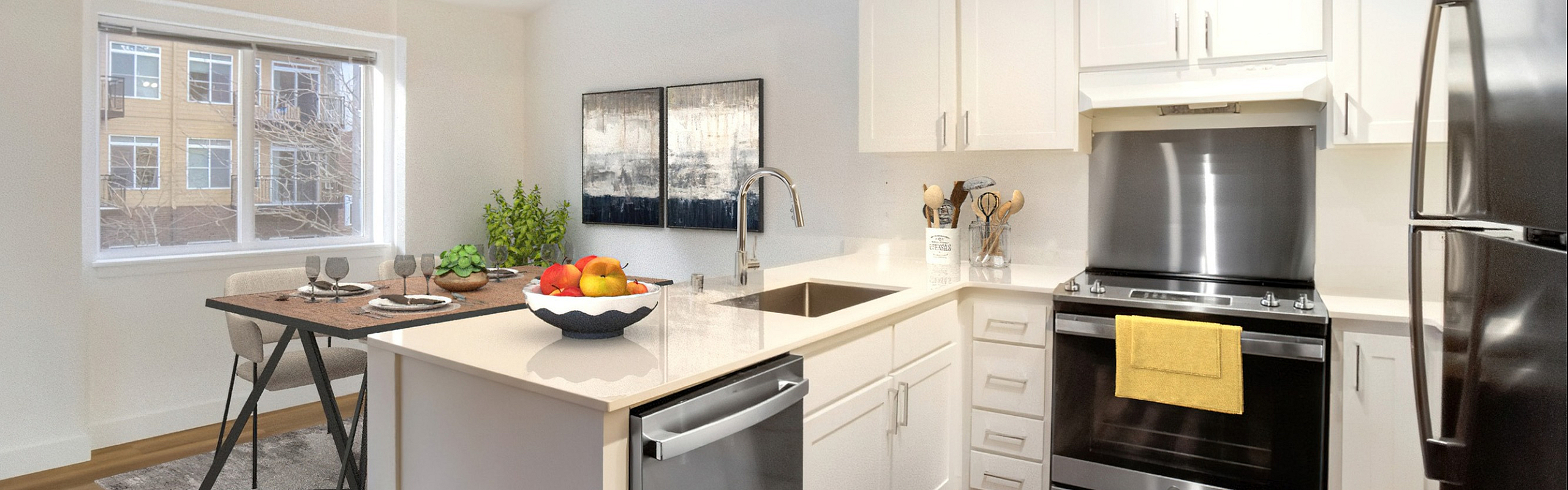 Contemporary kitchen with sleek stainless steel appliances, bright open dining area, and elegant wood flooring.