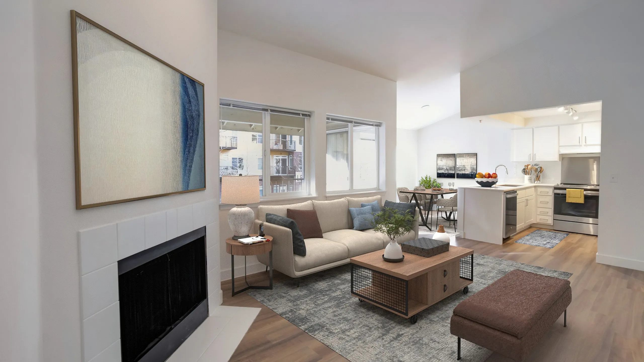 Inviting living room with modern decor, cozy fireplace, and open-concept kitchen, perfect for entertaining.