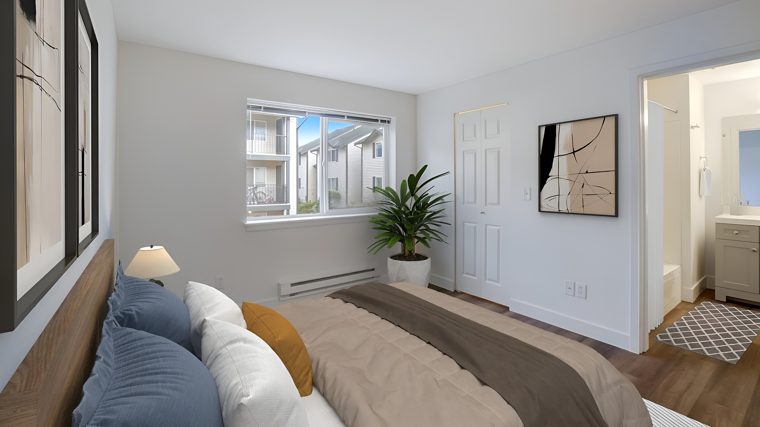 Bright and cozy bedroom featuring modern decor, large window with scenic view, and an ensuite bathroom.