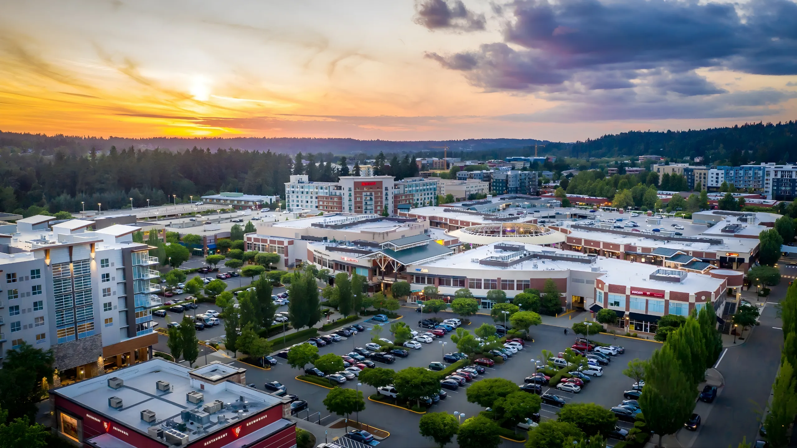 Vibrant cityscape at sunset with modern apartments, lush green spaces, and convenient shopping centers.