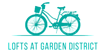 Turquoise bicycle illustration with the text 'Lofts at Garden District' beneath it.
