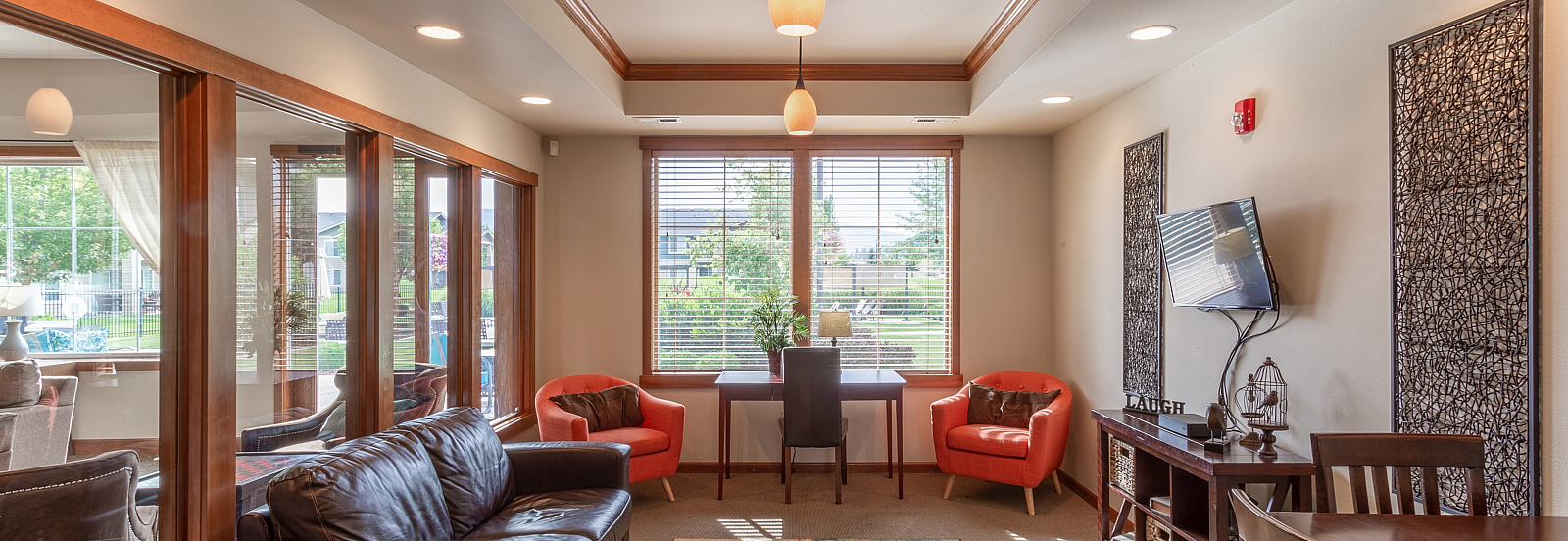 Cozy and inviting living room with stylish modern furniture, large windows providing plenty of natural light, and elegant decor for a warm ambiance.