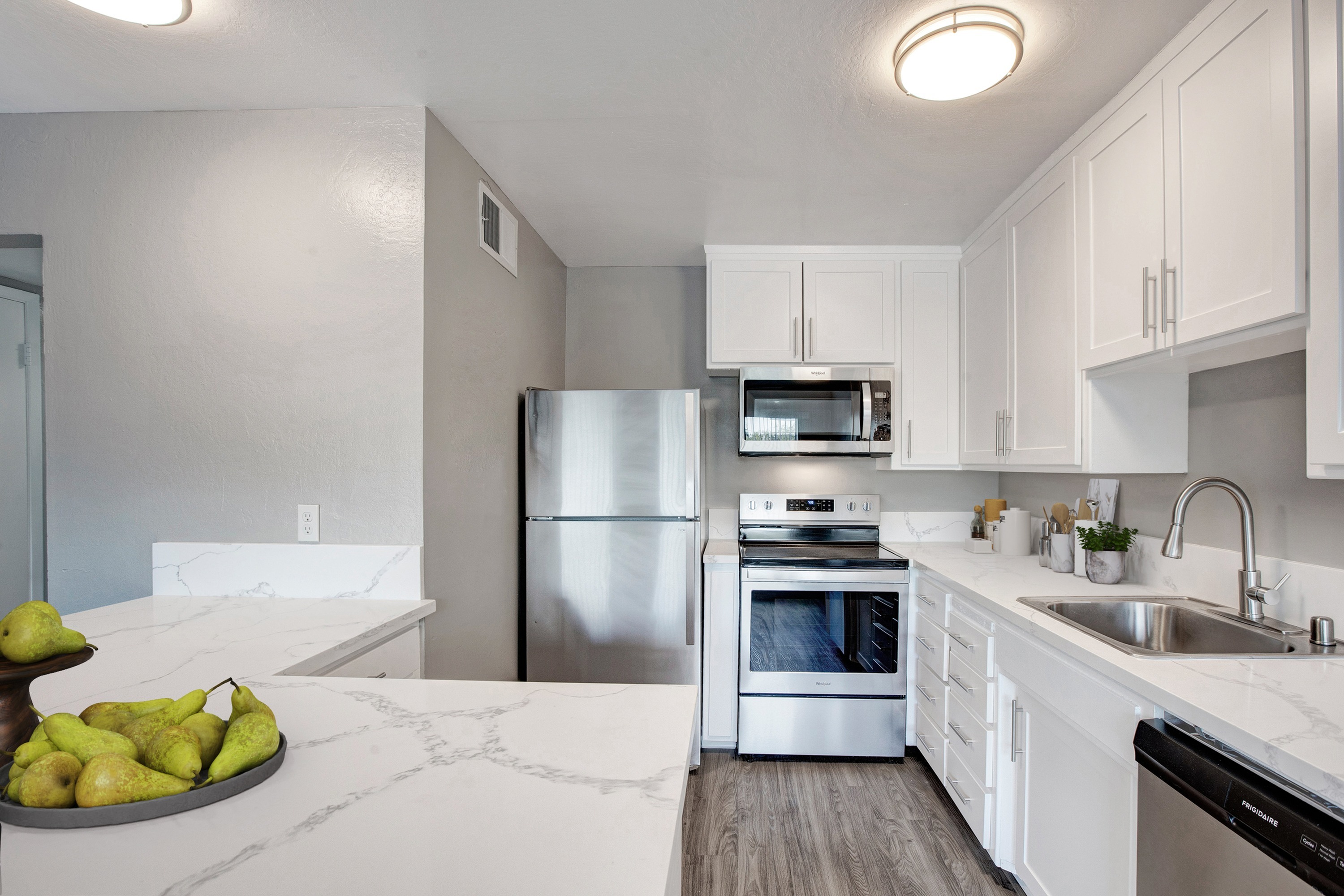 Renovated kitchen with quartz countertops and stainless steel appliances