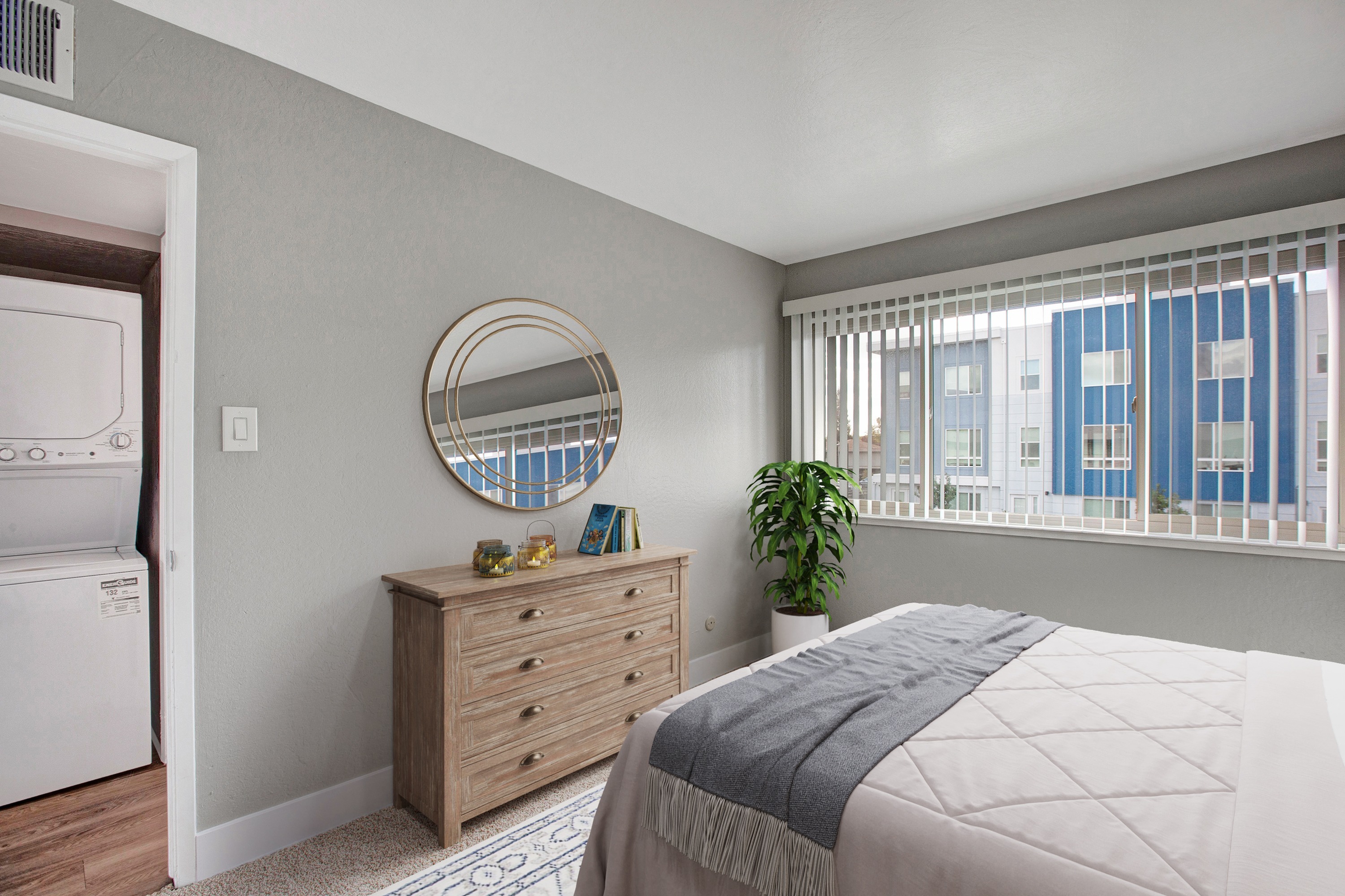 Bedroom with large window and in-unit laundry