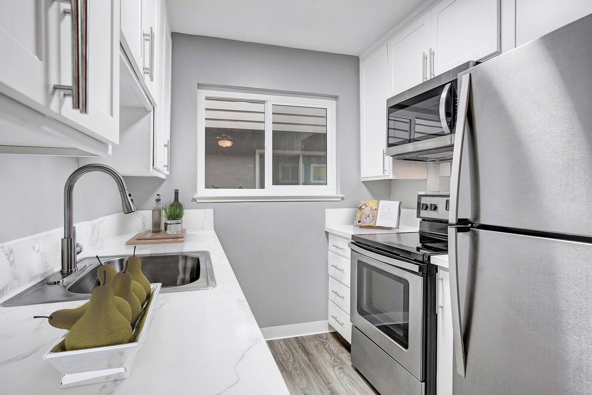 Renovated studio apartment kitchen with stainless steel appliances