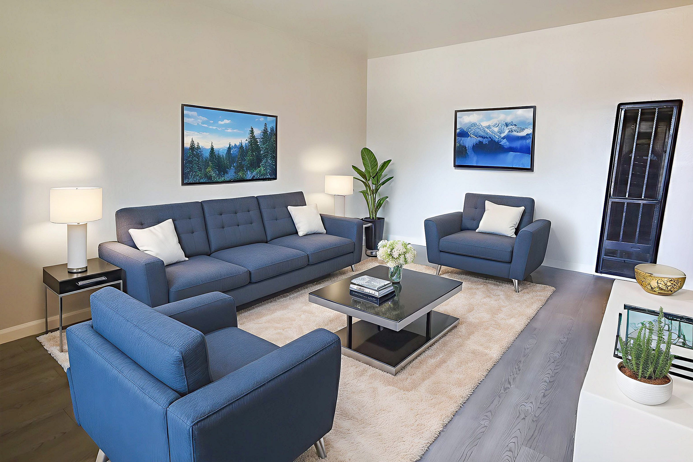 Living room with modern furnishings and navy blue couch and chairs