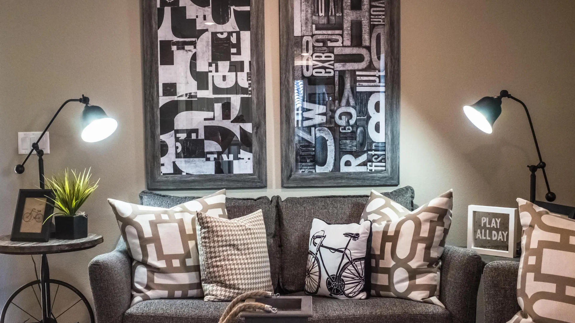 Livingroom couch staged with cushions, lighting and tables.