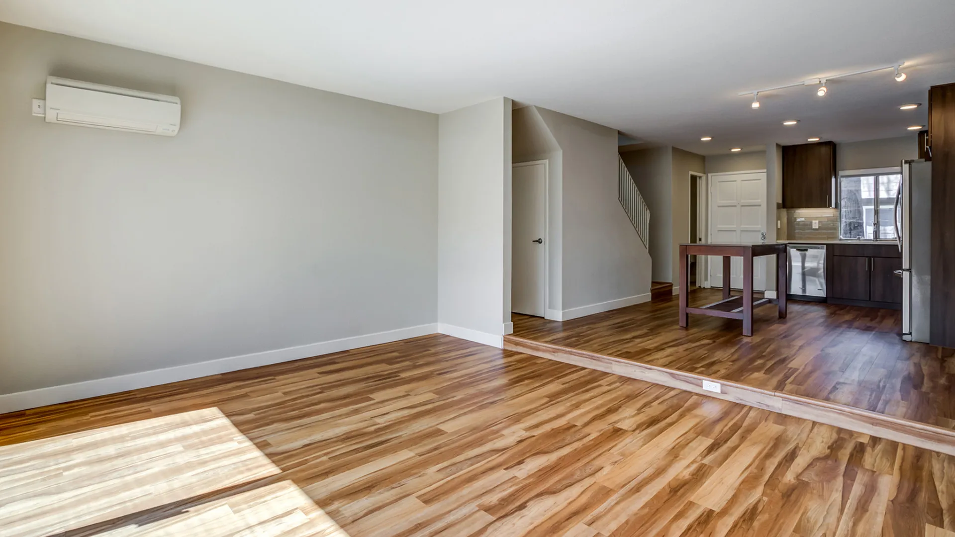 Renovated Living Room and Kitchen with stainless steel appliances and back splash