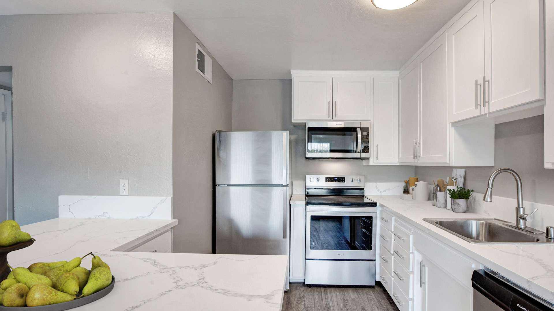 Modern kitchen with stainless steel appliances at MOXY apartments