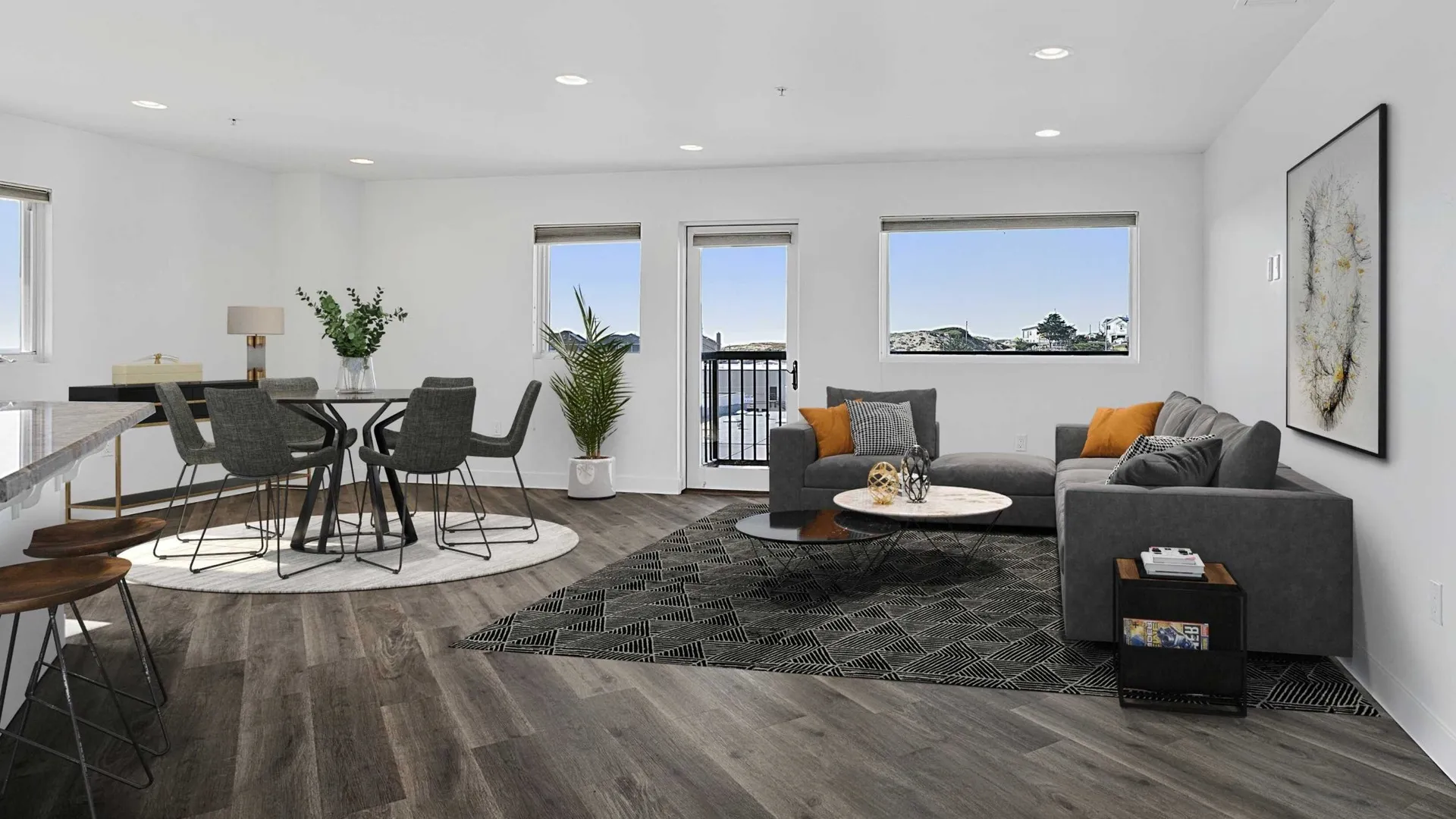 Living room and dining area with large windows and views