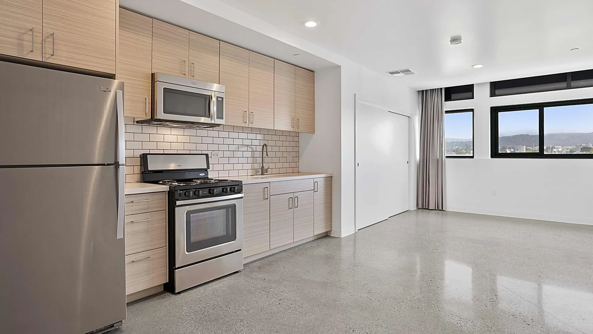 Living room and dining area with large windows and views