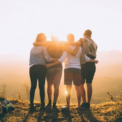 Friends watching the sunset on a hike