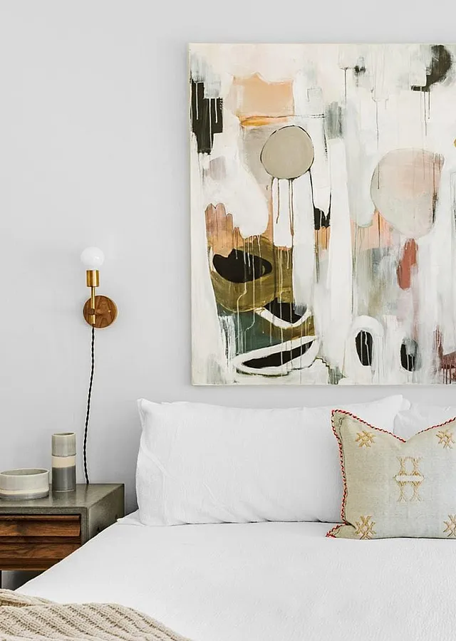 Luxurious bed with art on the wall
