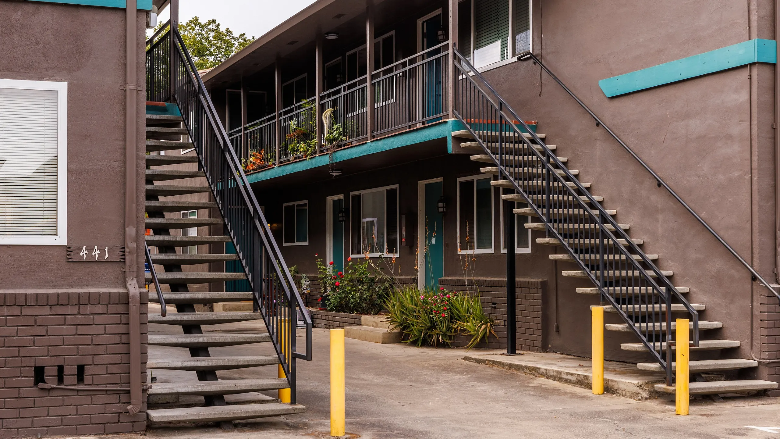 Phot of building exterior at Windy Hill Apartments showcasing two stairways, leading up to the second floor