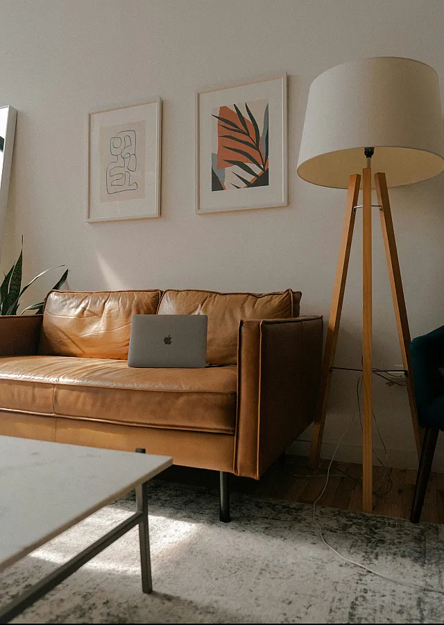 Livingroom vignette: Small couch, art on the wall and a floor lamp