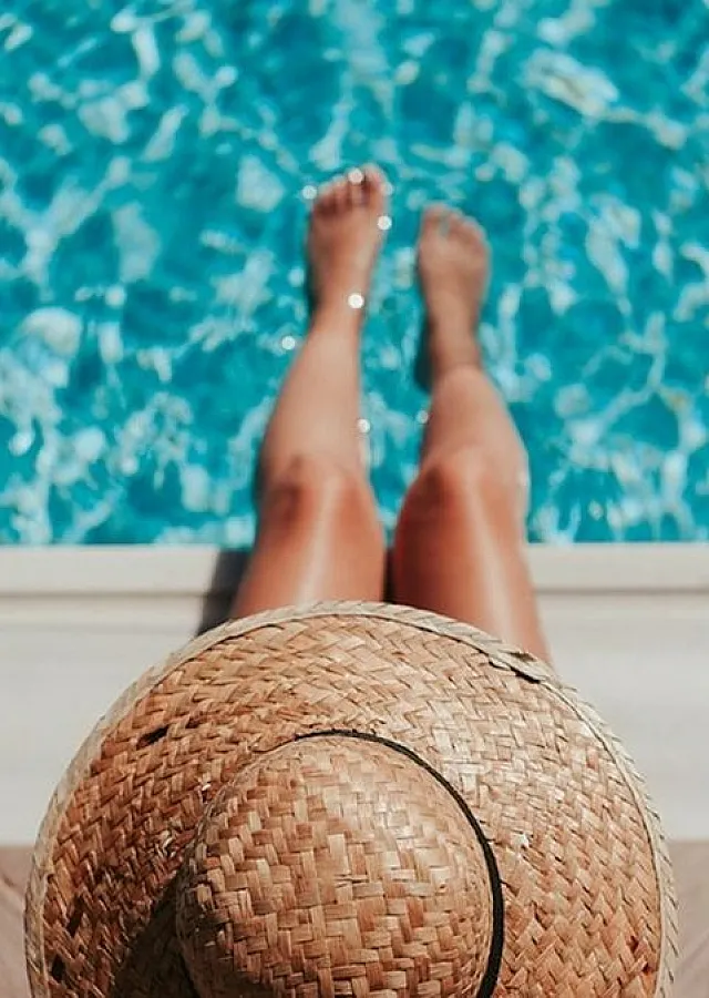 Sparkling pool with woman sitting poolside