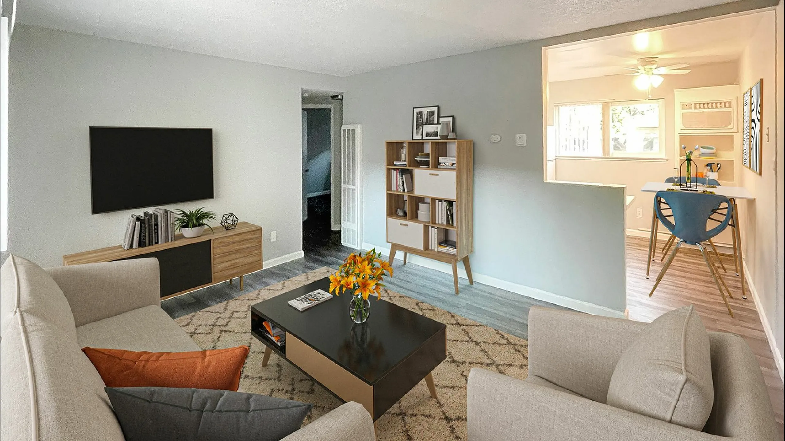 Staged livingroom with two couches, coffee table, Tv and console