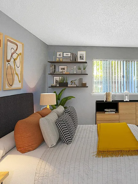Modern bedroom with gray walls, a cozy bed with orange and gray pillows, and a yellow throw. Shelves with decor, a dresser, and open closet. Bright, inviting atmosphere.