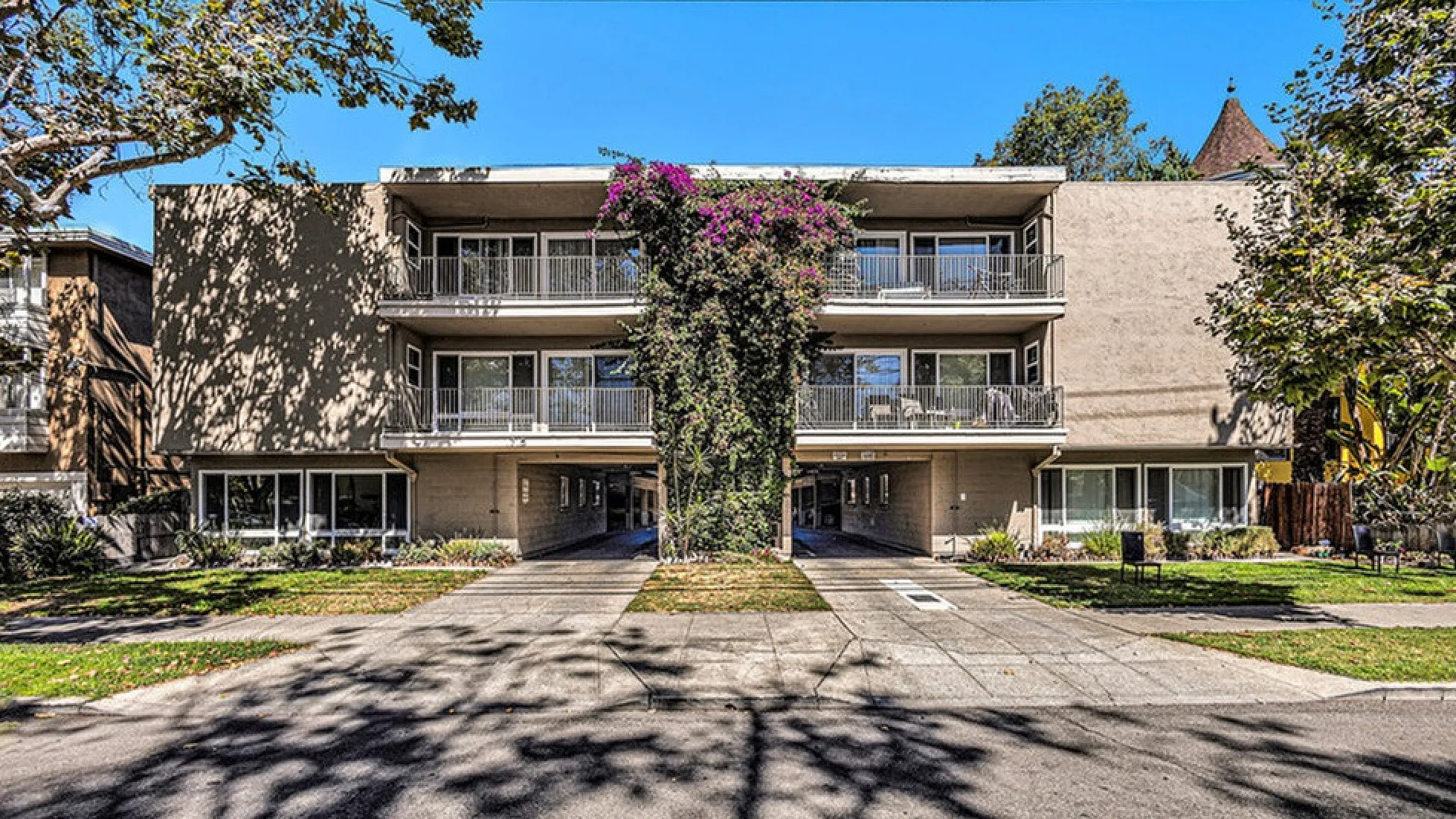 Exterior 2 story building photo with balconies and covered parking