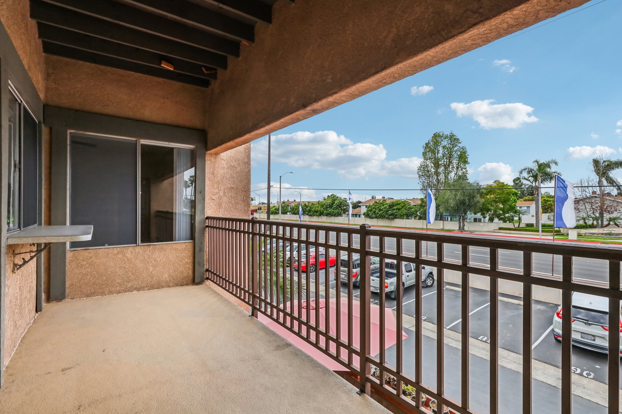 Inviting balcony with picturesque views, ideal for relaxation and enjoying the vibrant surrounding neighborhood.