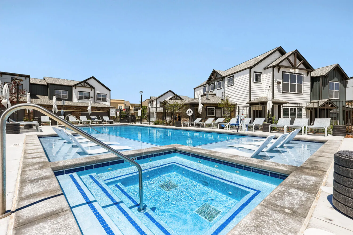 Hot tub with jets next to the resort-style pool at Ara Townhomes & Flats in Castle Rock, Colorado