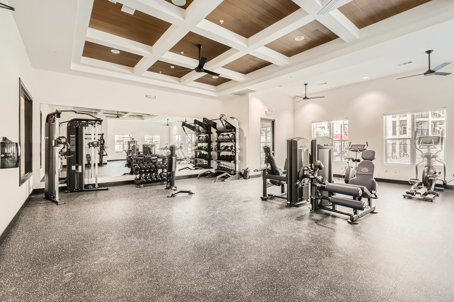 Weight-lifting equipment and cardio machines in the fitness center at Agave Ranch Apartments in Glendale, AZ.
